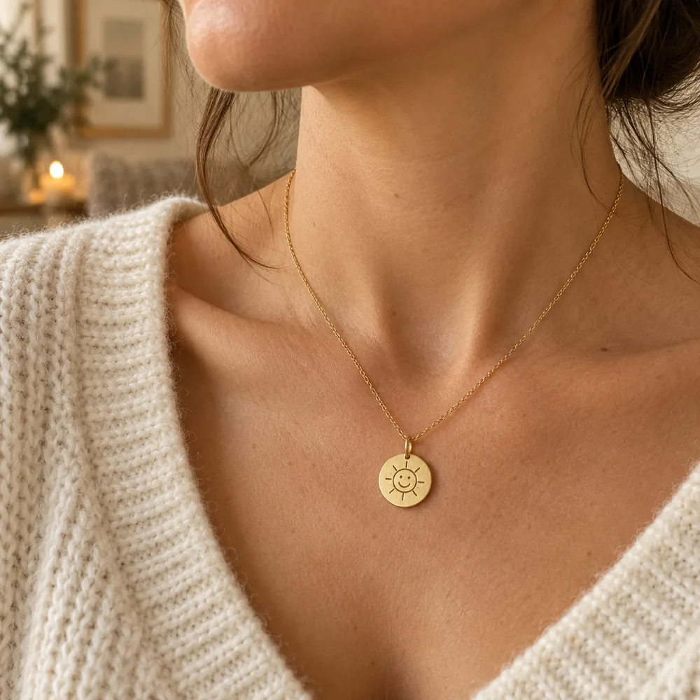 A sunshine disc necklace worn below the collarbone
